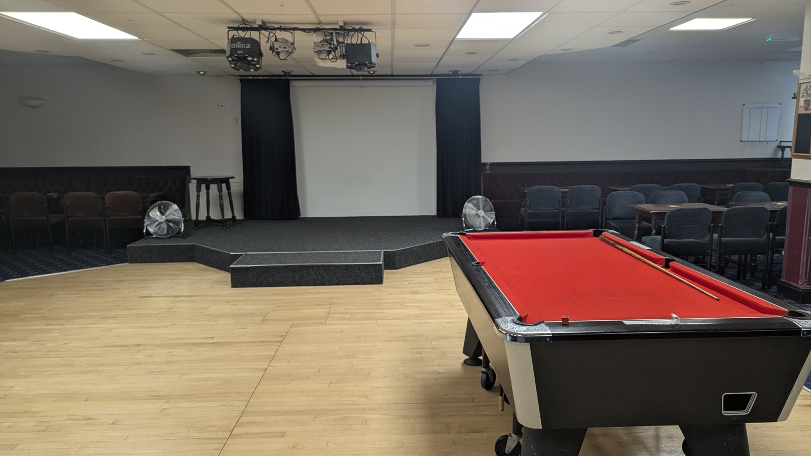 Pool table with the stage and dance floor behind